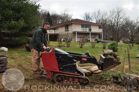 moving rock with a mini skid steer|Moving landscape rocks with the mini skid steer .